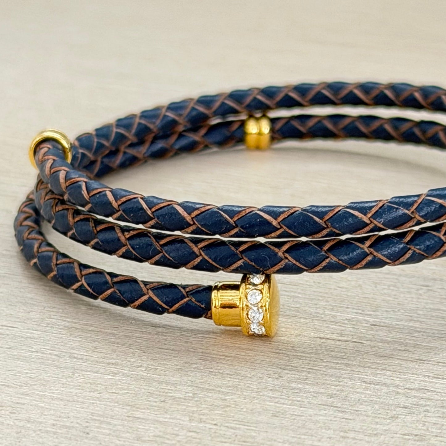 Brown braided leather bracelet with gold accents 