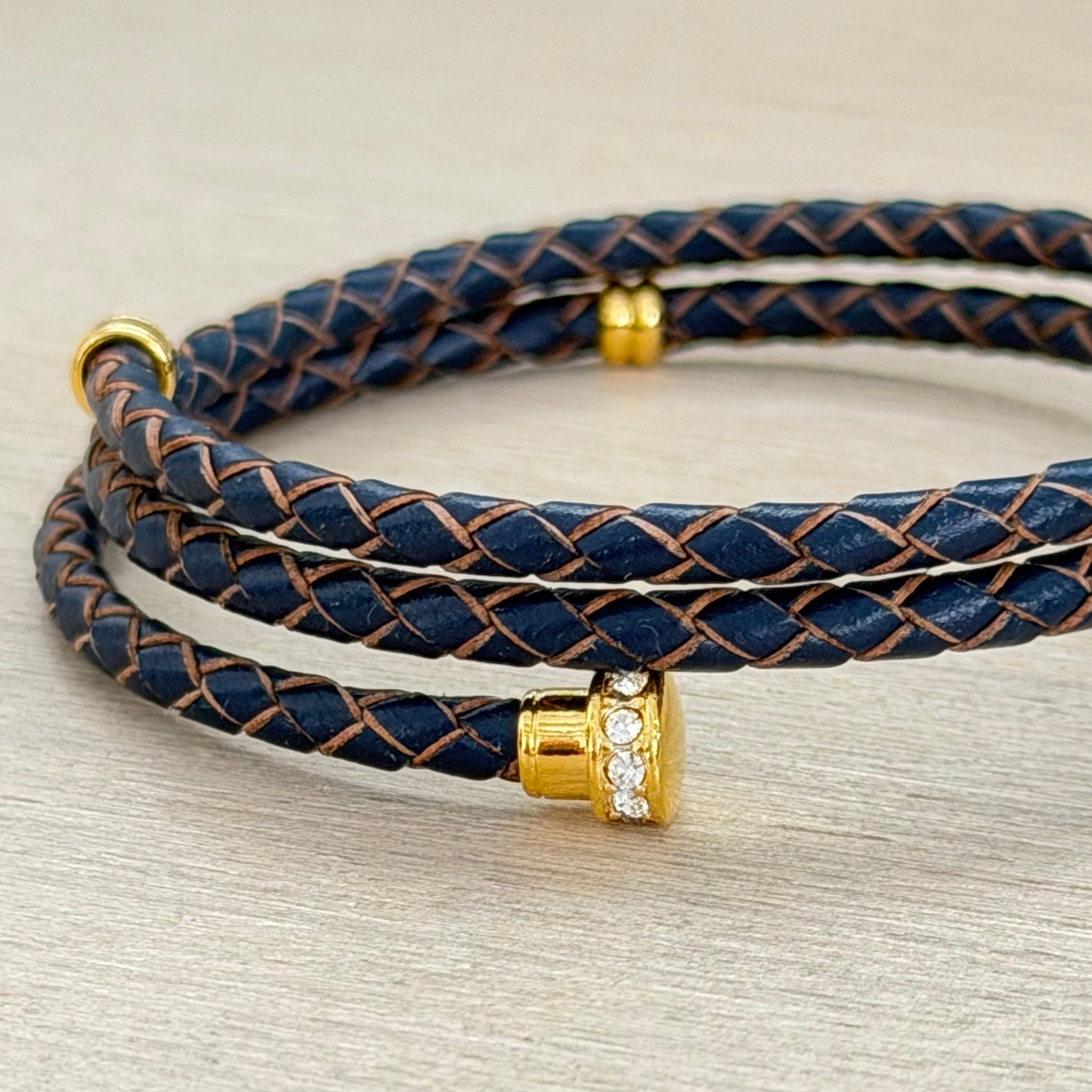 Brown braided leather bracelet with gold accents 