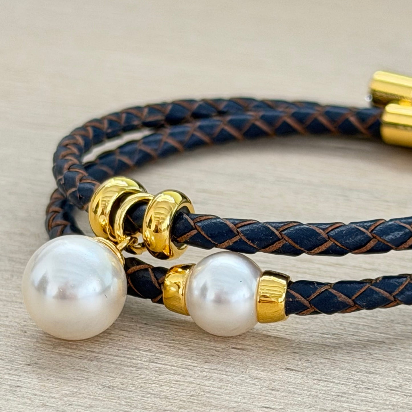 Bracelet with pearls and gold accents on a neutral background